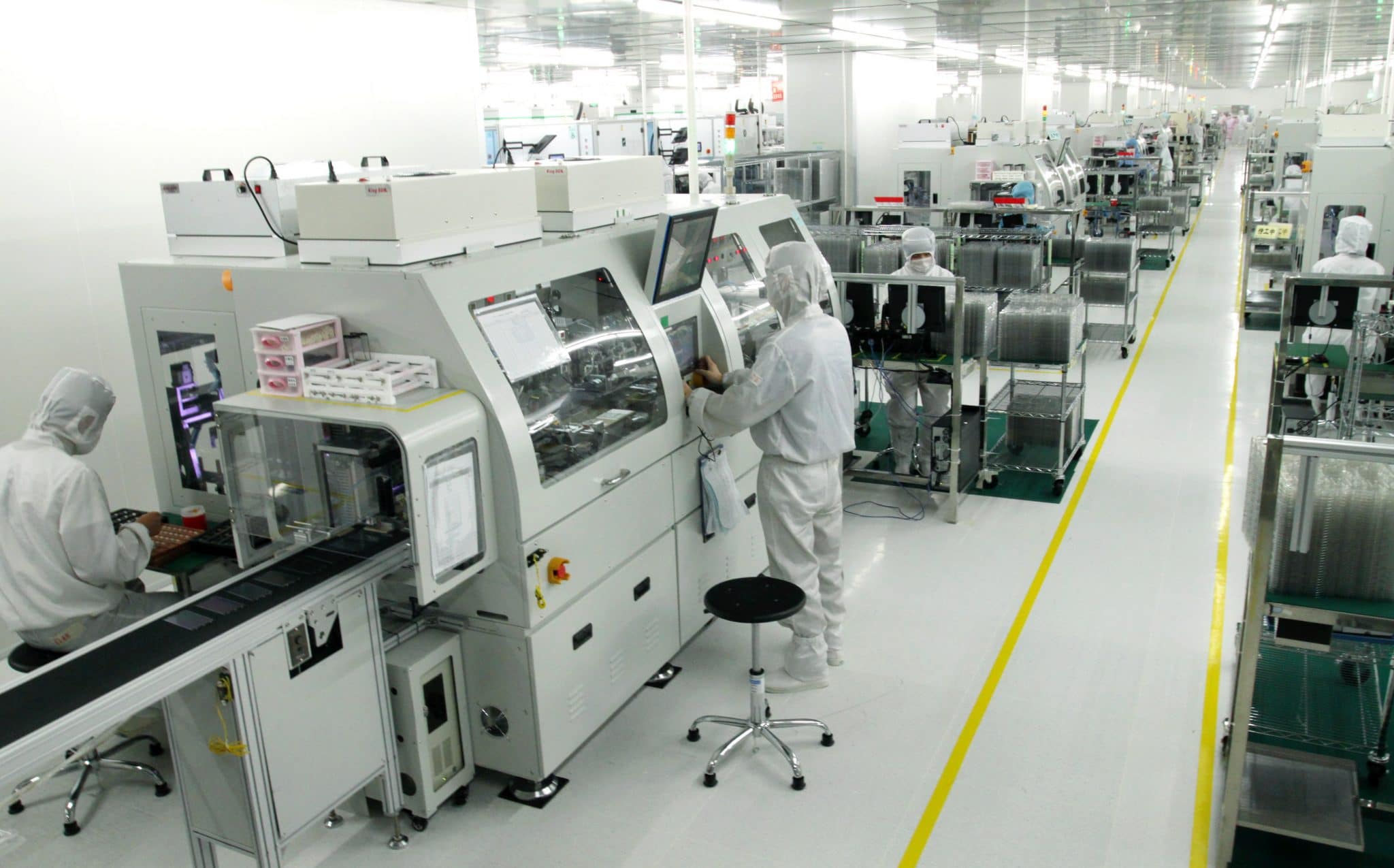 Orient Display cleanroom production line, with operators in cleanroom suits at automated assembly stations
